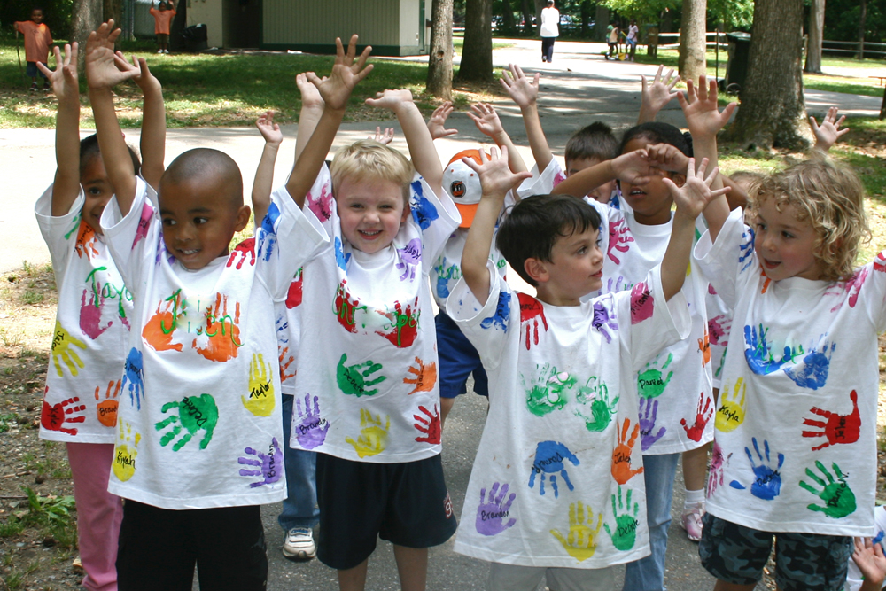 kids with hand prints on their white t-shirt
