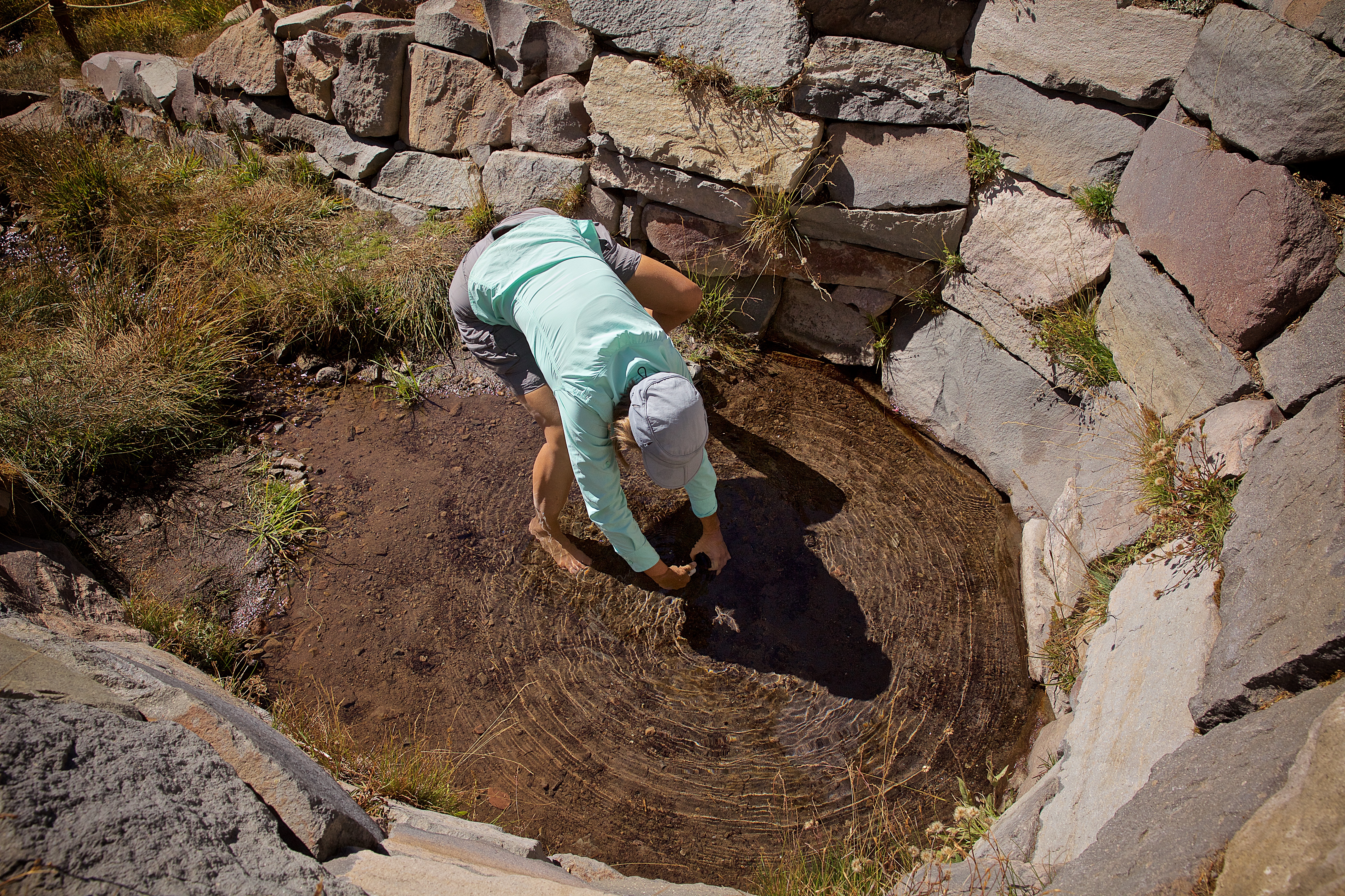 Dr. Jean Moran taking water samples from a pool beneath some Folded Sediments near San Andreas Fault