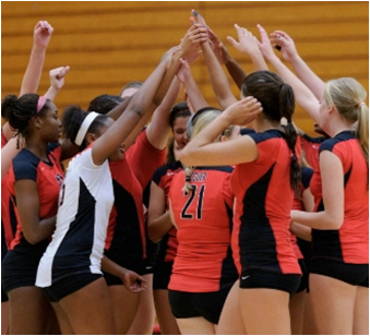 CSUEB volleyball team cheering before a game.