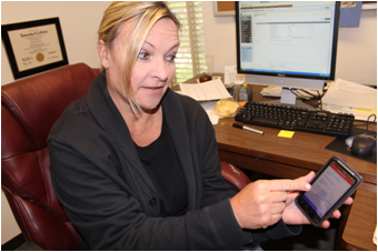 Assistant Political Science Professor Elizabeth Bergman demonstrates her new voter app created in partnership with Atwoodz, Inc. (By: Chase Thomas, The Pioneer)