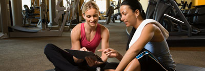 A personal trainer helps her client