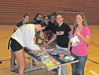 student-athletes assemble care packages