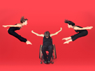 Man in wheelchair, two women in high jumps.