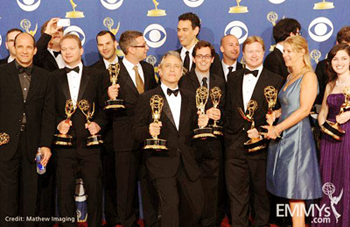 group of Daily Show writers, including JR Havlan at left and host Jon Stewart at center, holding Emmy award statues