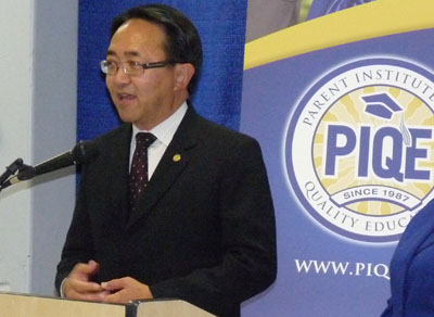 CSUEB President Leroy Morishita stands in front of a crowd of parents at the PIQE graduation. (By: Elias Barboza)