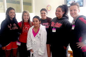 Visiting 10-year old Christina (center) at the hospital were Pioneer softball players Mandy Dale, Kelsey Cairns, Vika Kafoa and Andrea Scott. Coach Barbara Pierce is at the far right. (By: Hayward PD)
