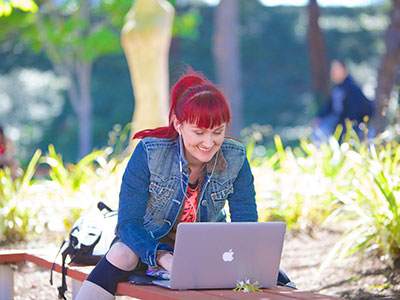 A student works at her laptop