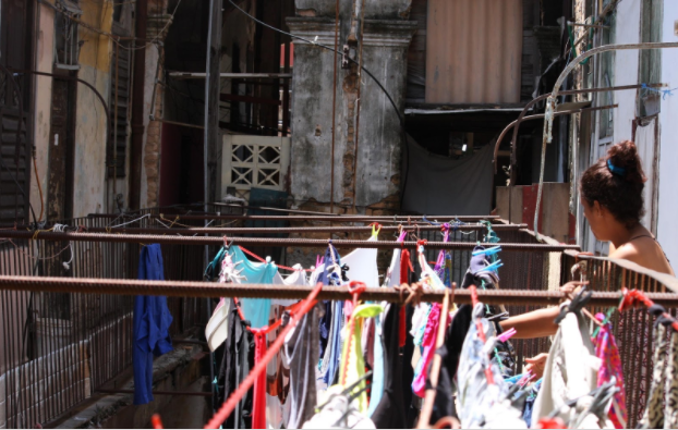 woman hanging laundry in cuba