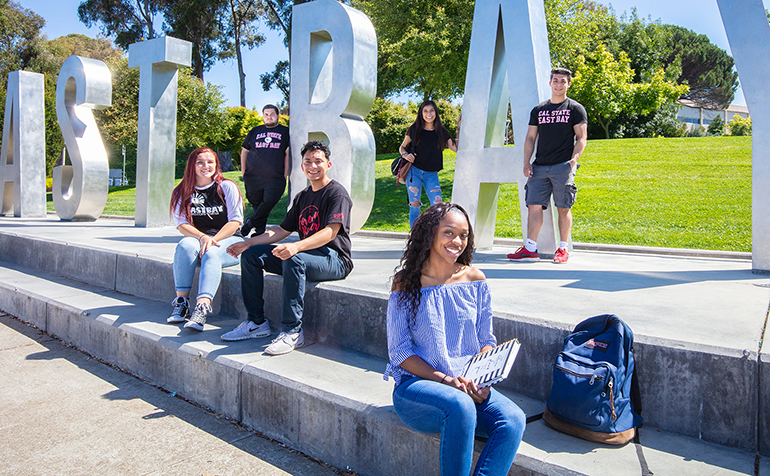 Several students stand in front of East Bay Letters