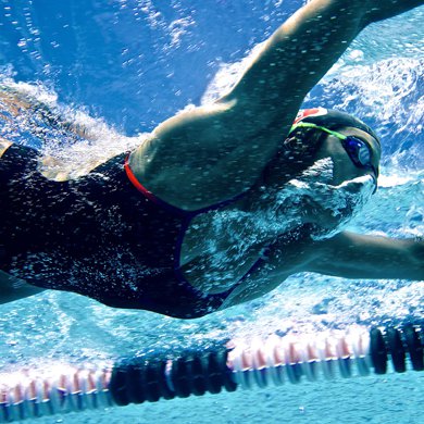 A female swimmer glides through the water