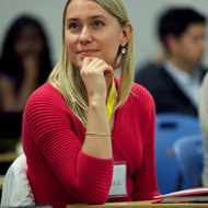 A young women in a red sweater is deep in thought