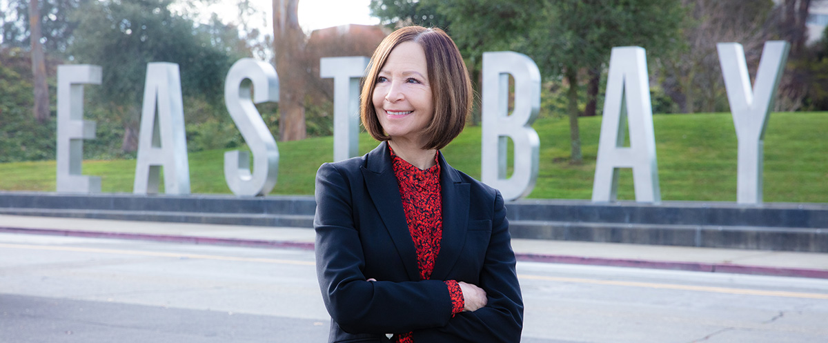 President Sandeen in front of the East Bay letters