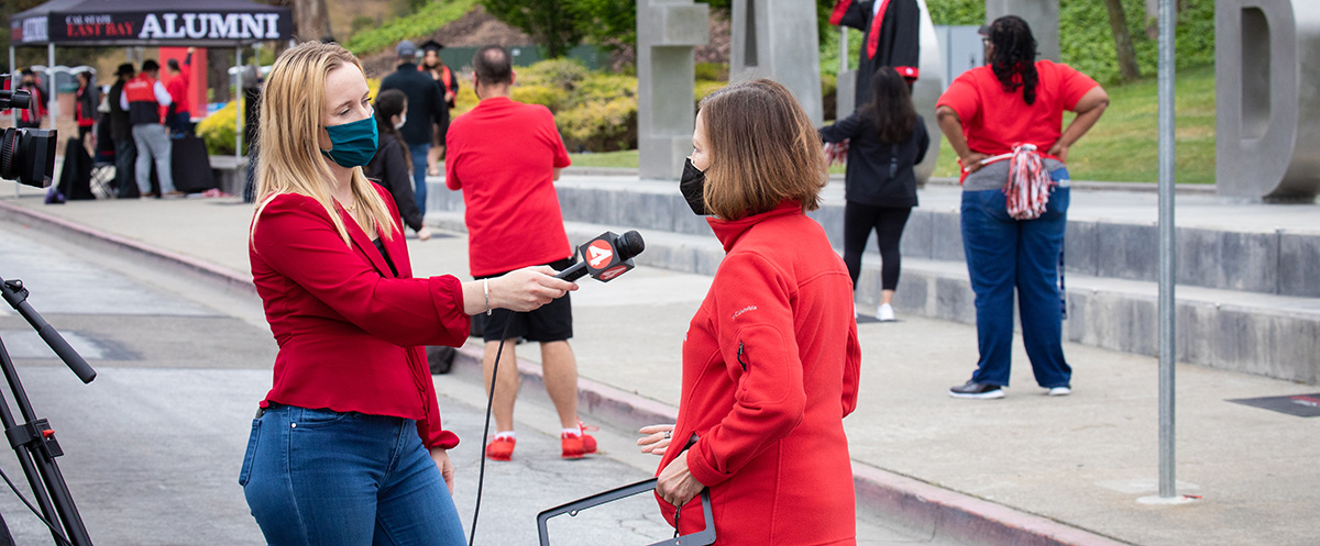 President Sandeen talks with a reporter