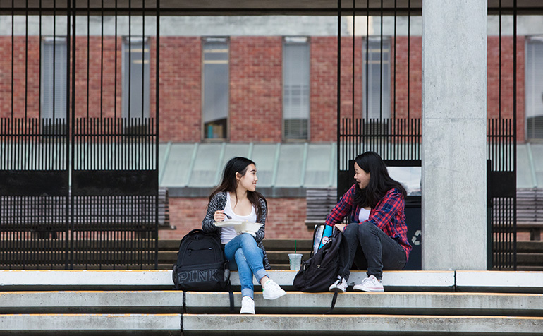 Students sitting on the stairs of a building