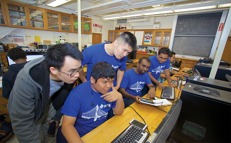 Students working together looking at computer