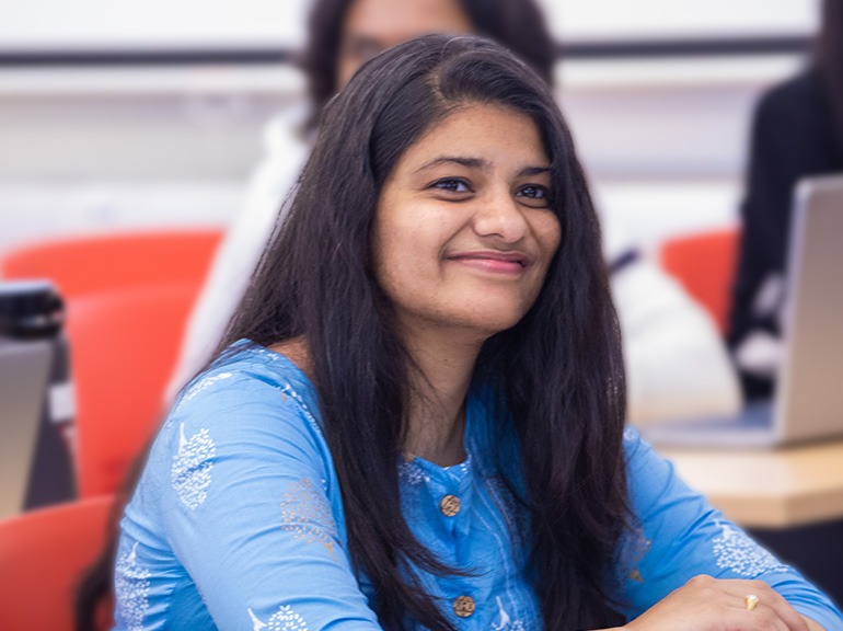 Female student smiling in a classroom