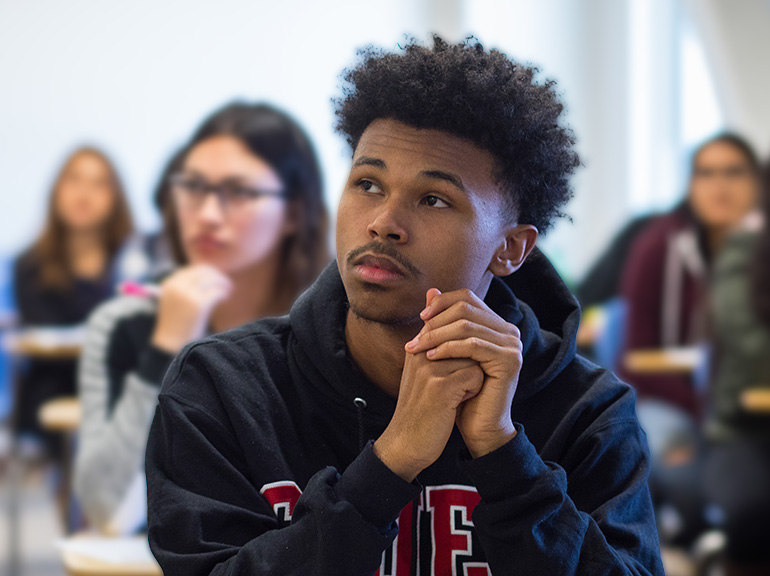 Male student engaged in a classroom environment