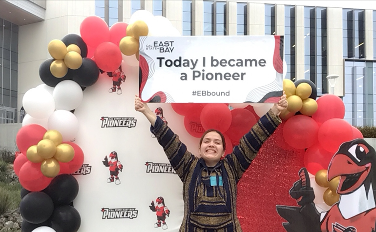 Student holding sign that reads Today I became a pioneer