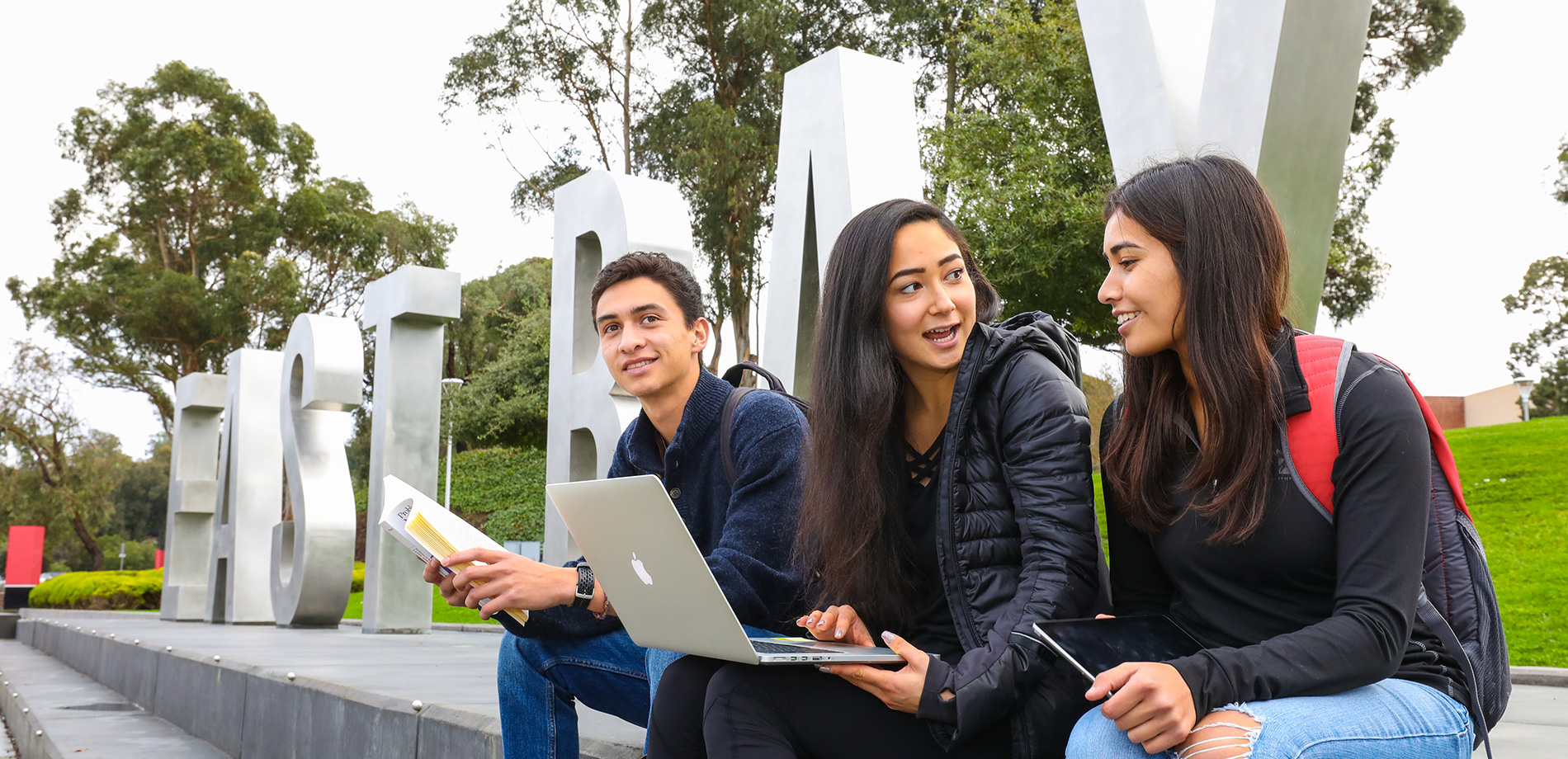 students in front of letters