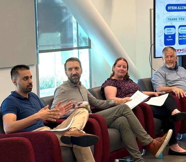 A group of three men and one women sitting in chairs talking