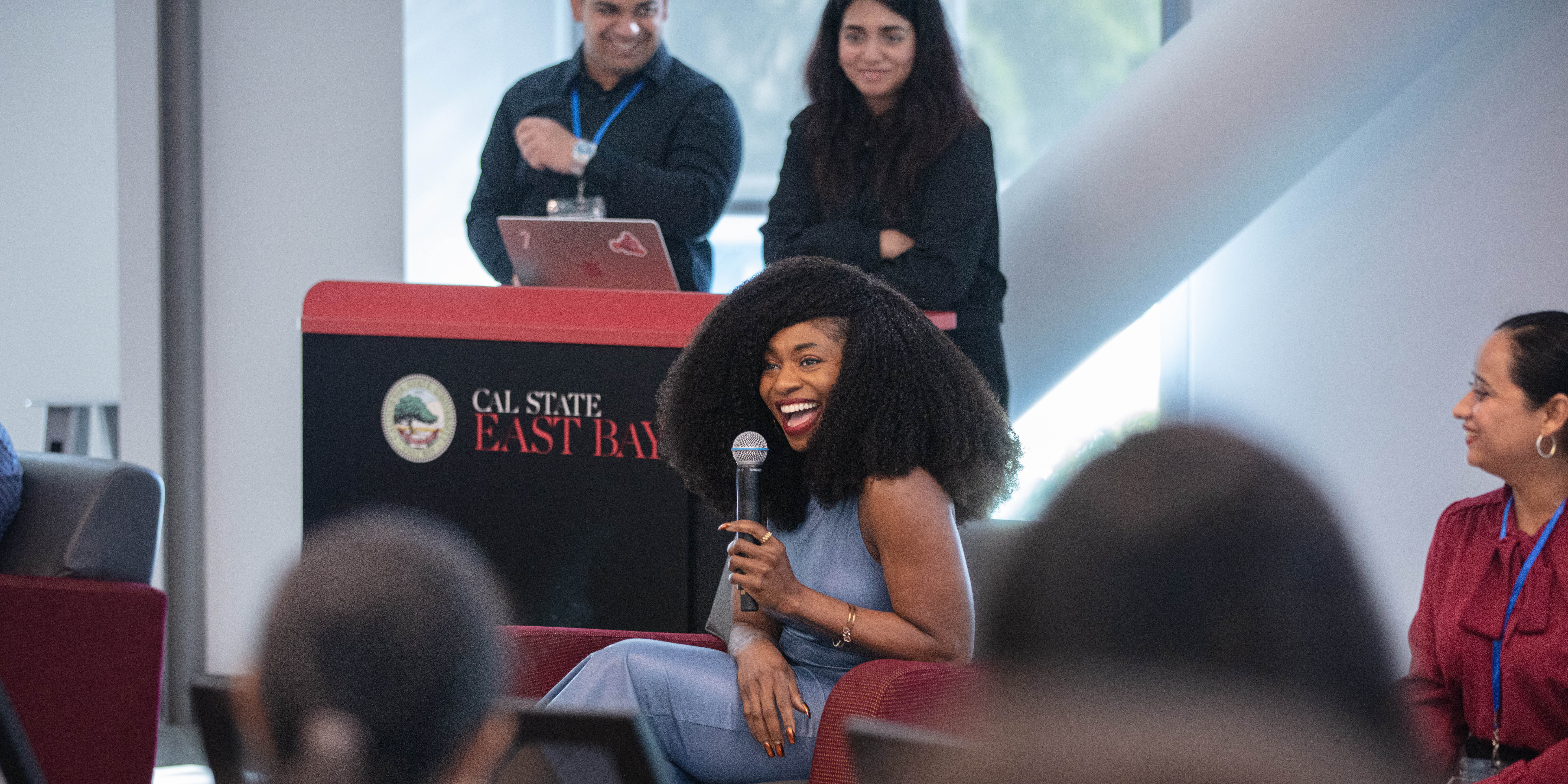 alumnus in front of a group of students presenting