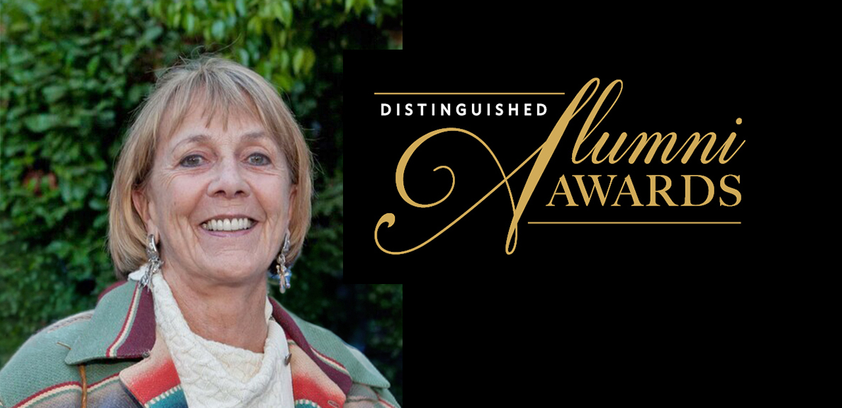 A women, smiling with the words "distinguished Alumni Awards" next to her
