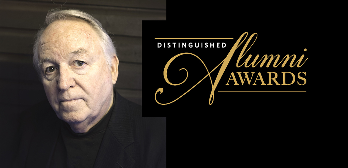 Dakin smiling with the words "distinguished alumni award" next to him