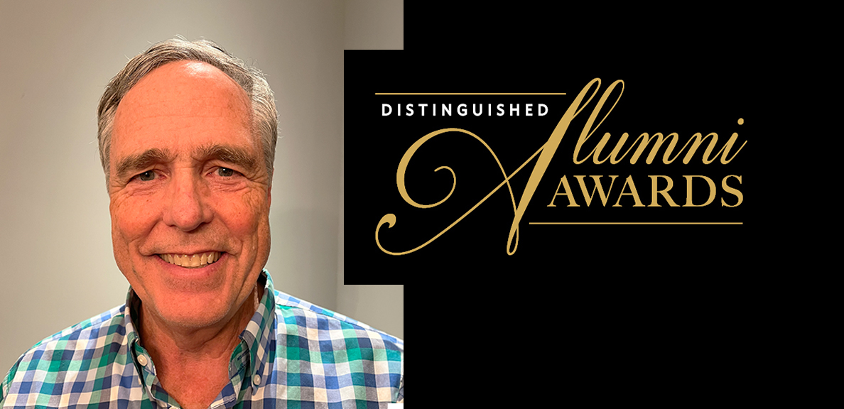 Brad smiling with the words "Distinguished Alumni Awards" next to him