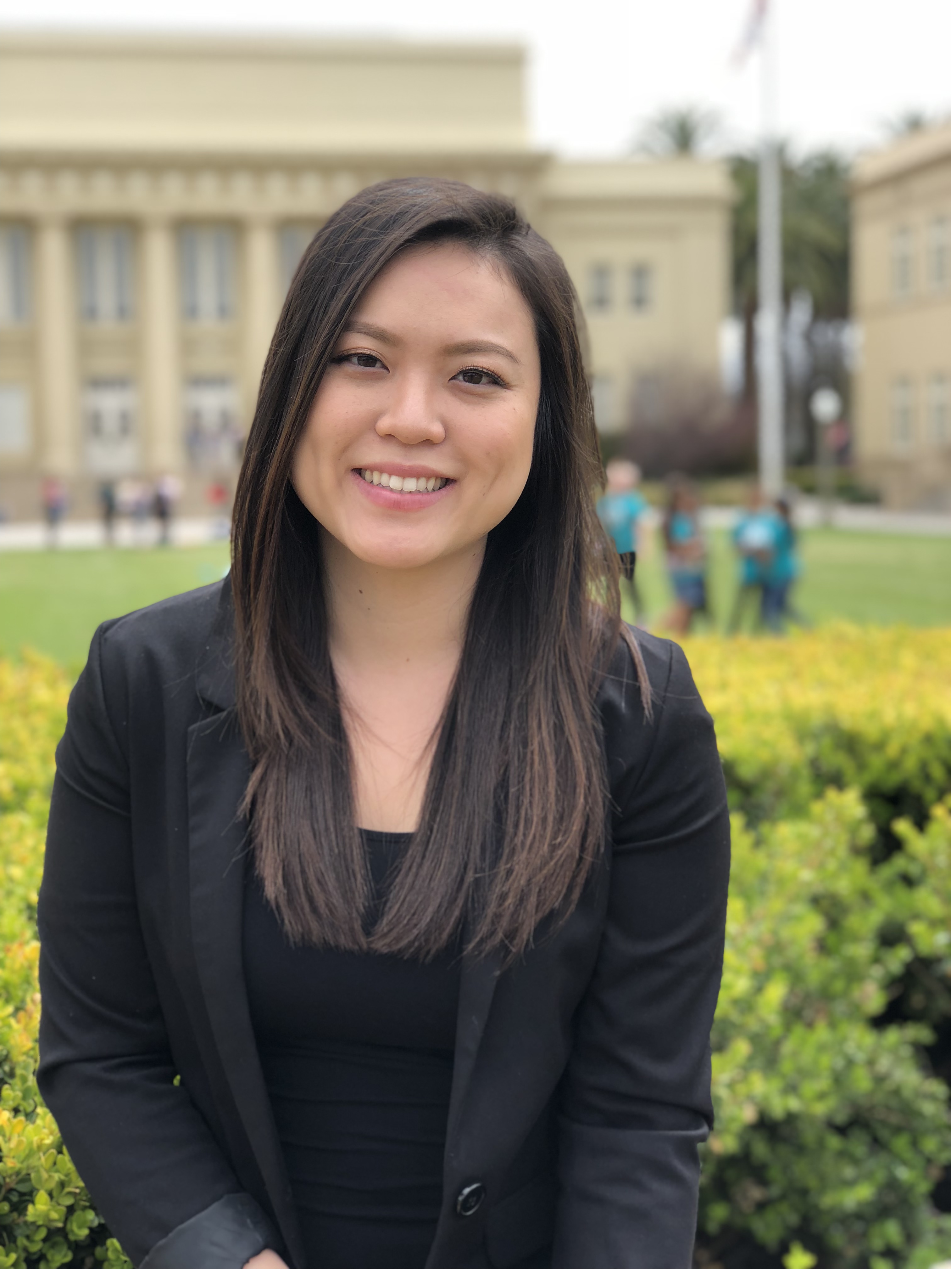 Vietnamese woman with shoulder length black hair, smiling.