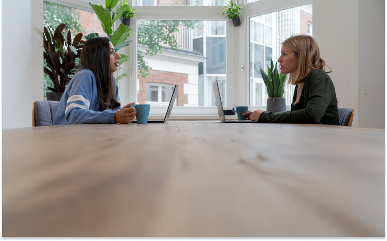 two people are talking in a meeting