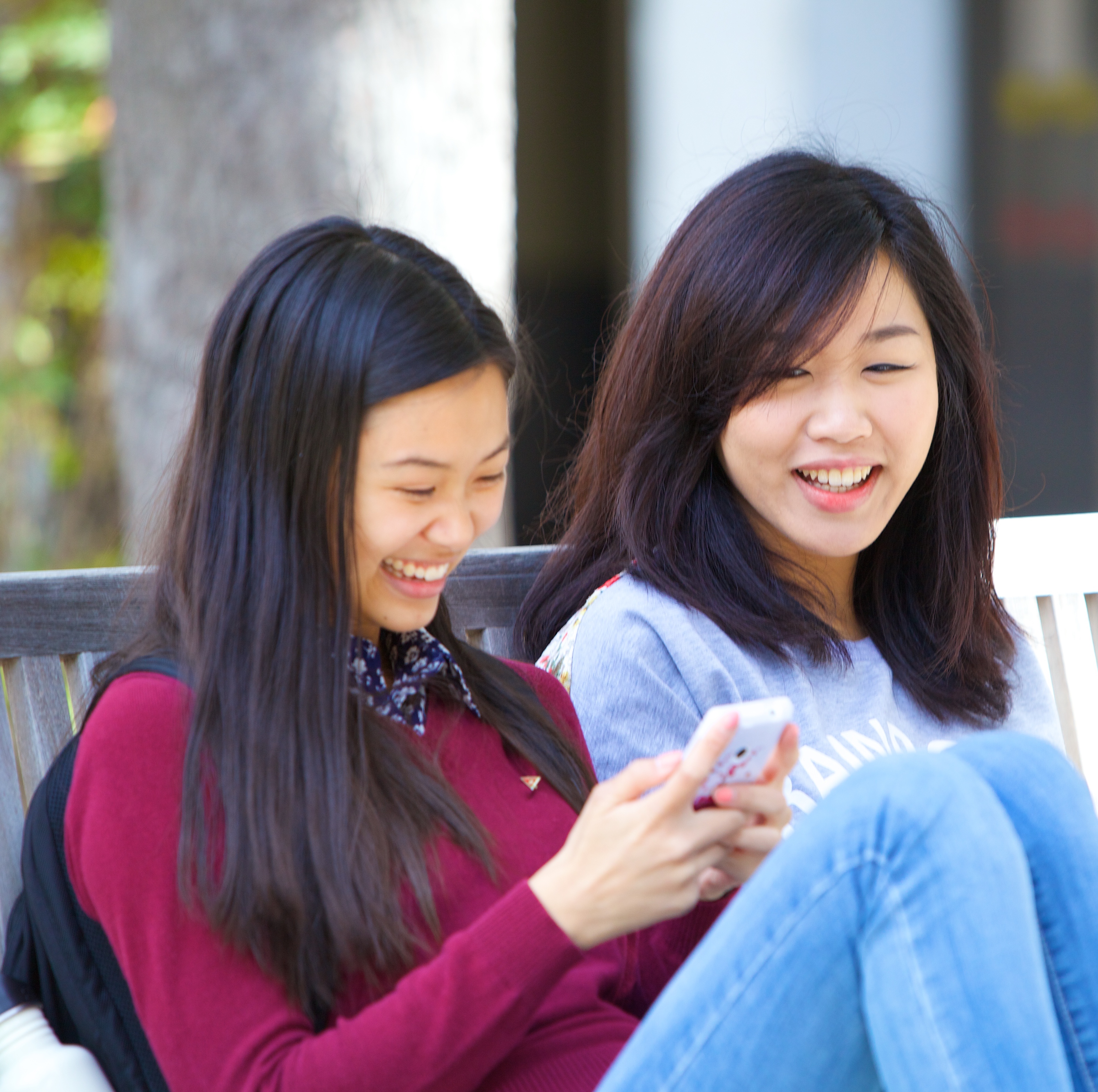 Two Women looking at a phone and smiling