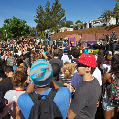 Students watching a band perform on stage