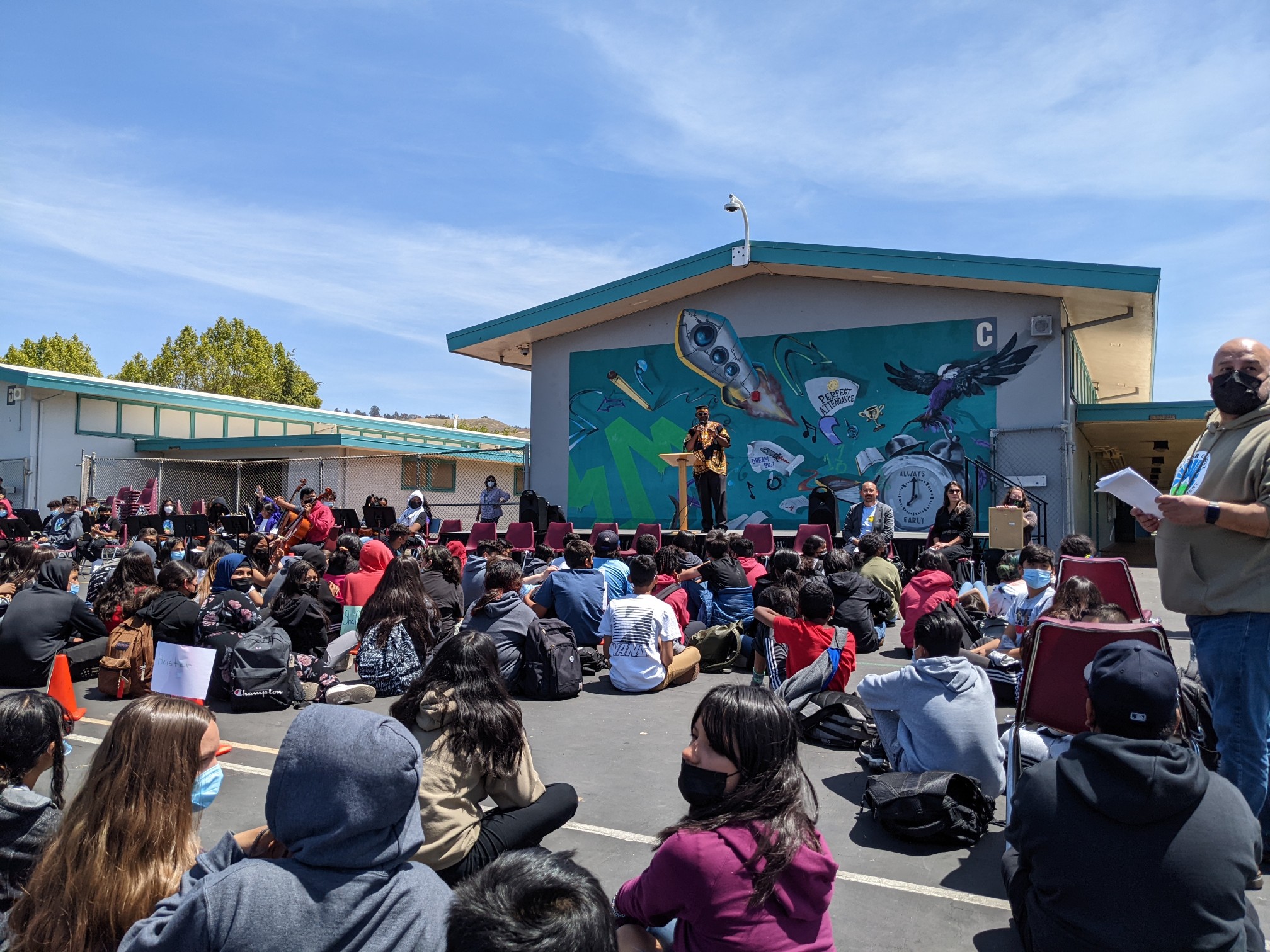 Students listen to a speech for community development.