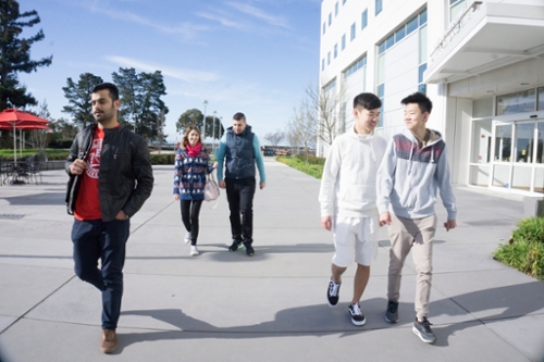 A diverse group of students walking by the VBT building