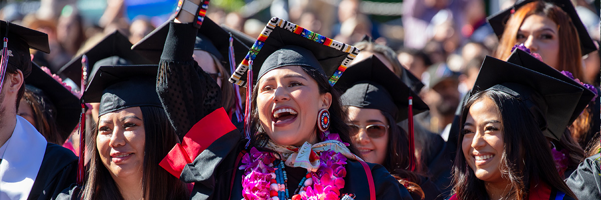 Female graduates cheering during commencement