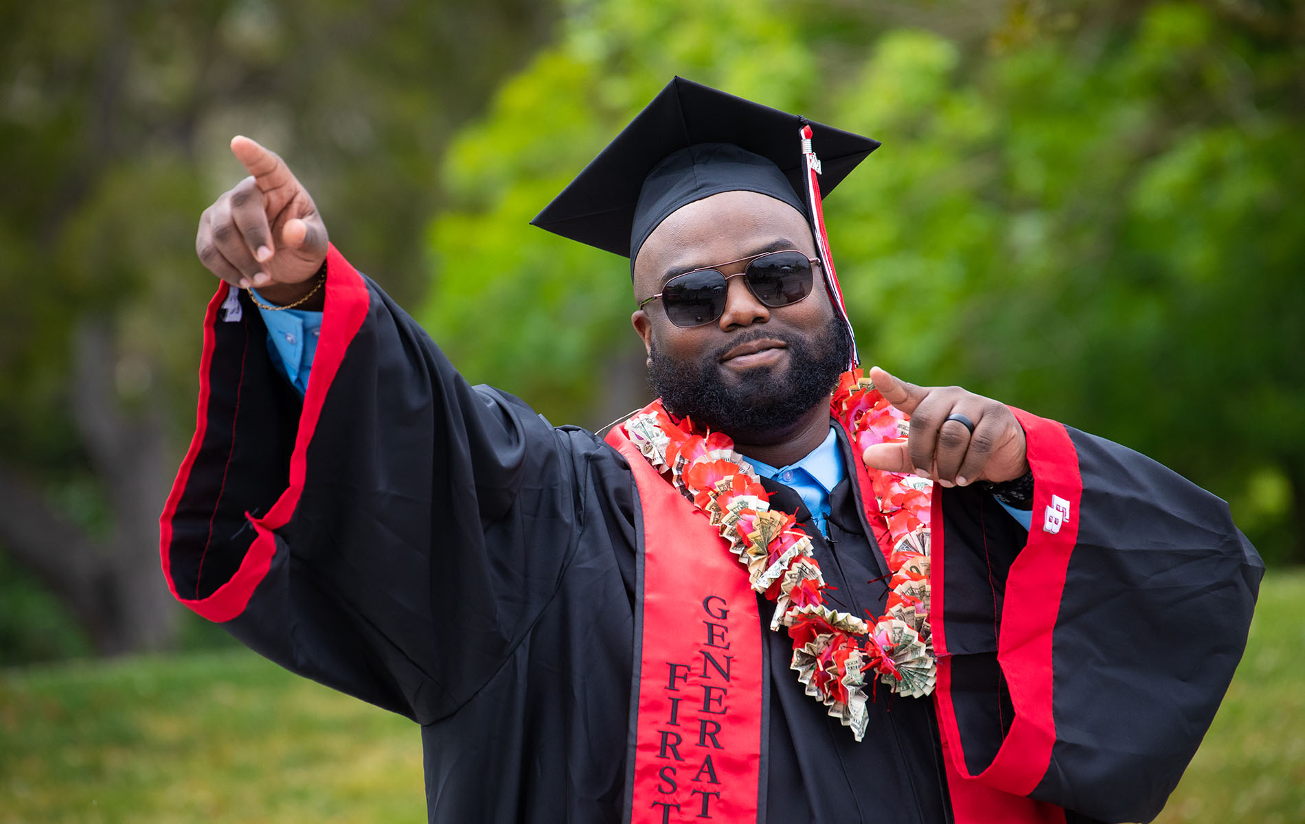 Graduate in cap and gown gestures