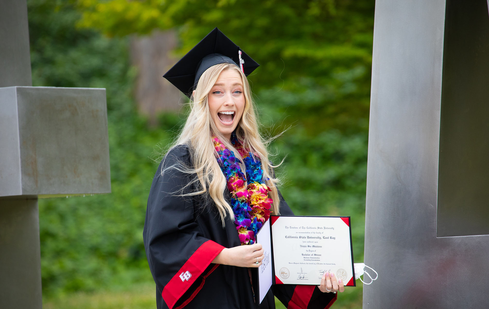 Graduate shows excitement showing off diploma
