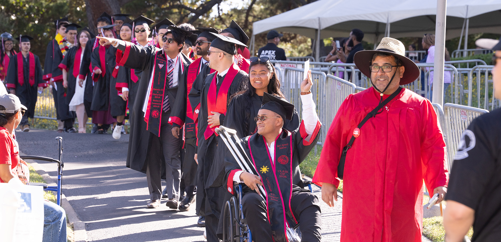 Graduates being led in a line to the amphitheater