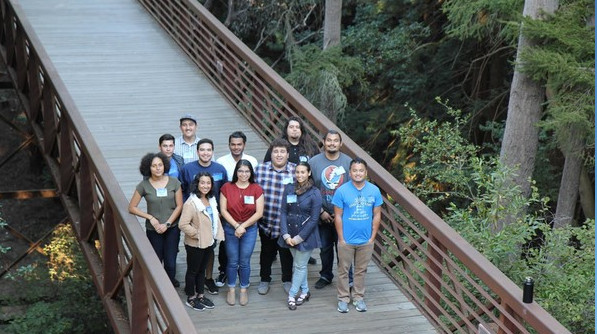 Cal-Bridge academic scholars standing on a bridge smiling at the camera