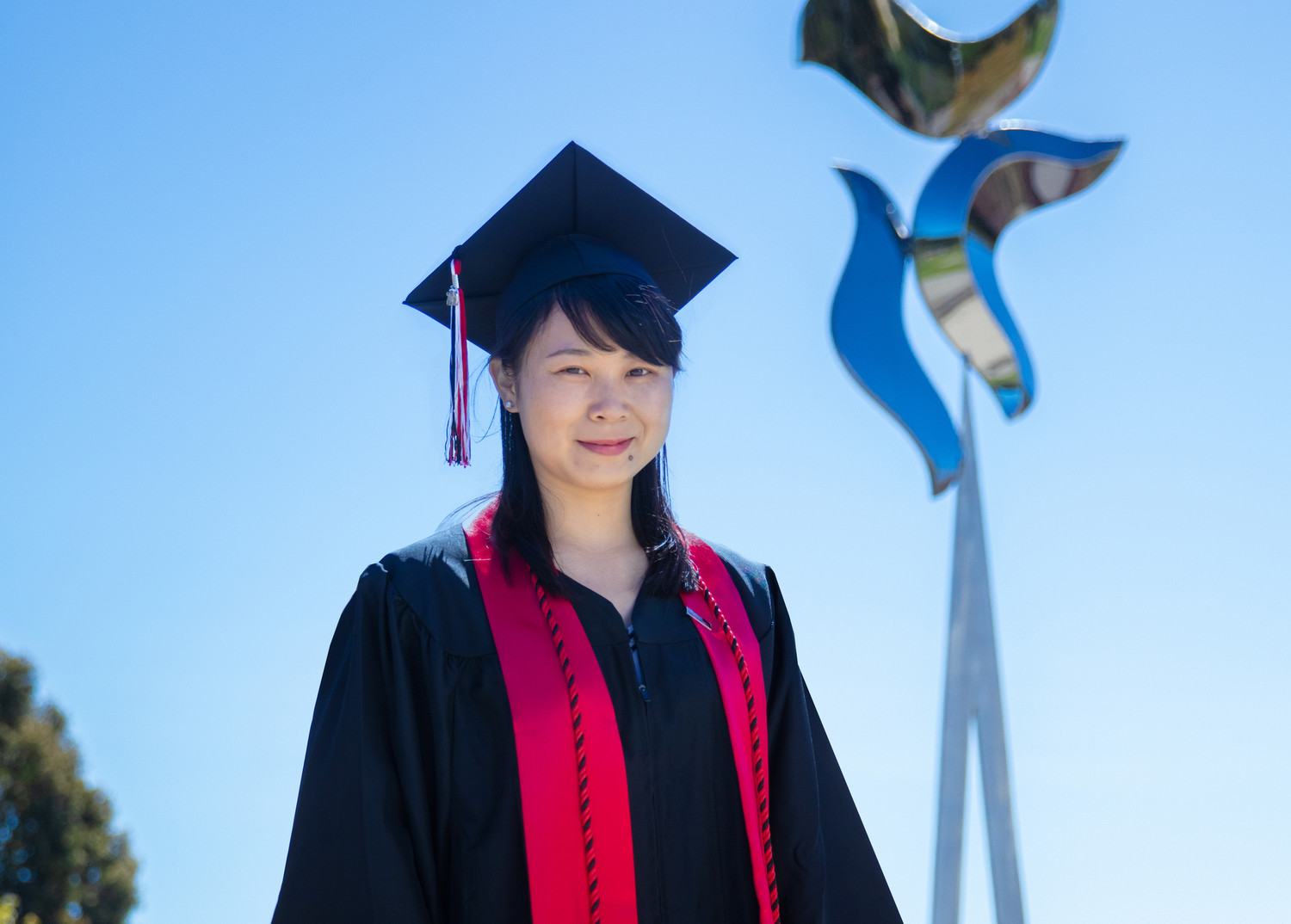 Chunli Cao smiling in cap and gown