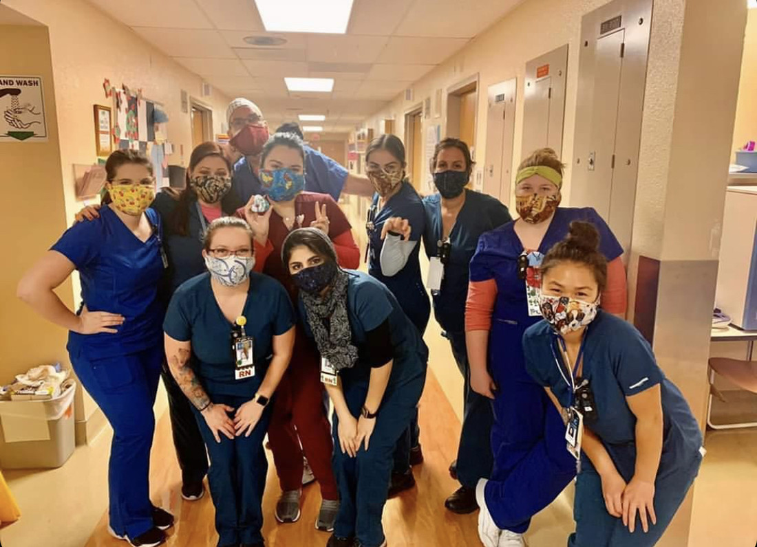 Nurses posing and smiling in a hospital wing
