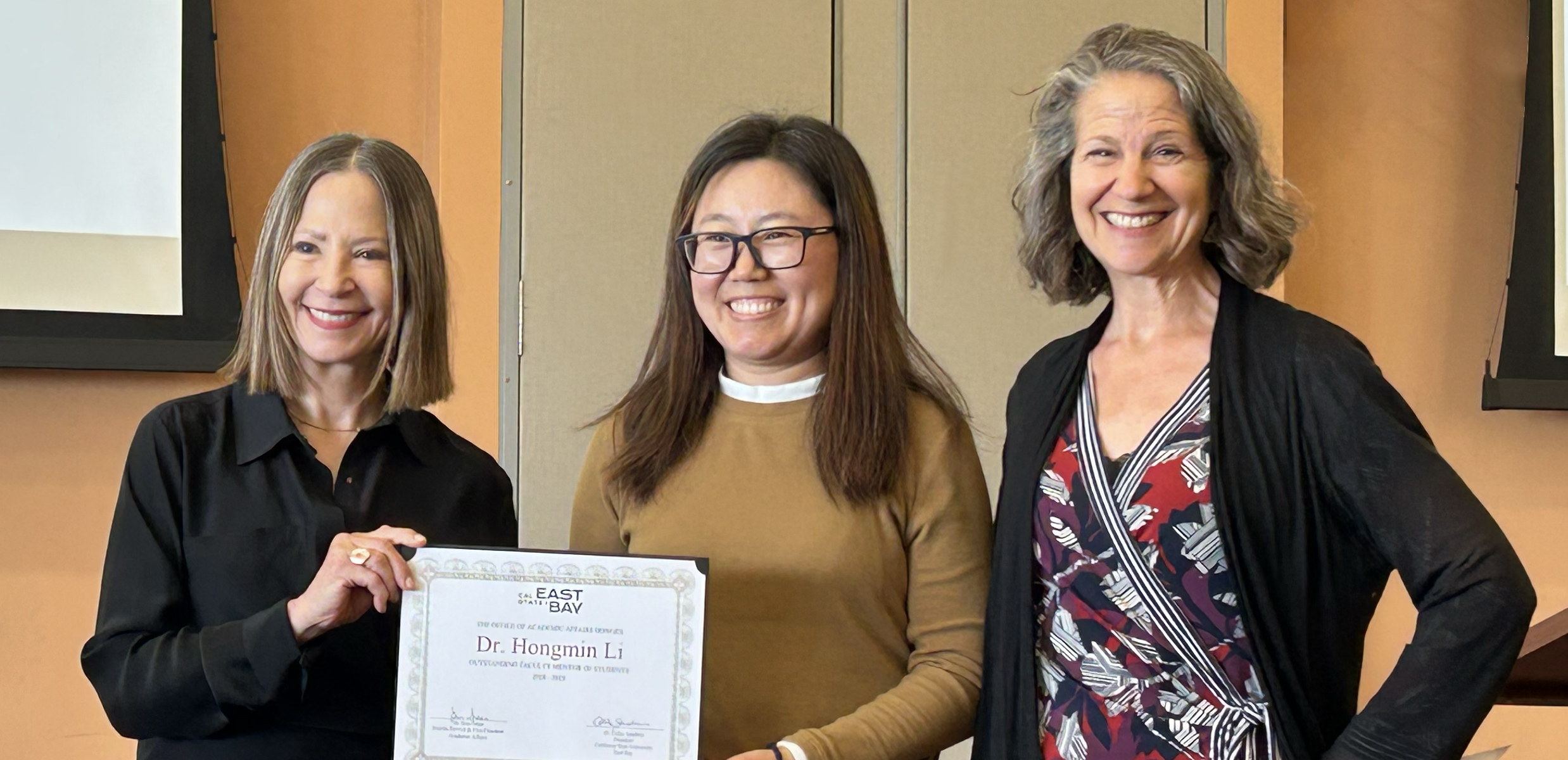 Photo of Hongmin Li at Faculty Awards with award certificate.