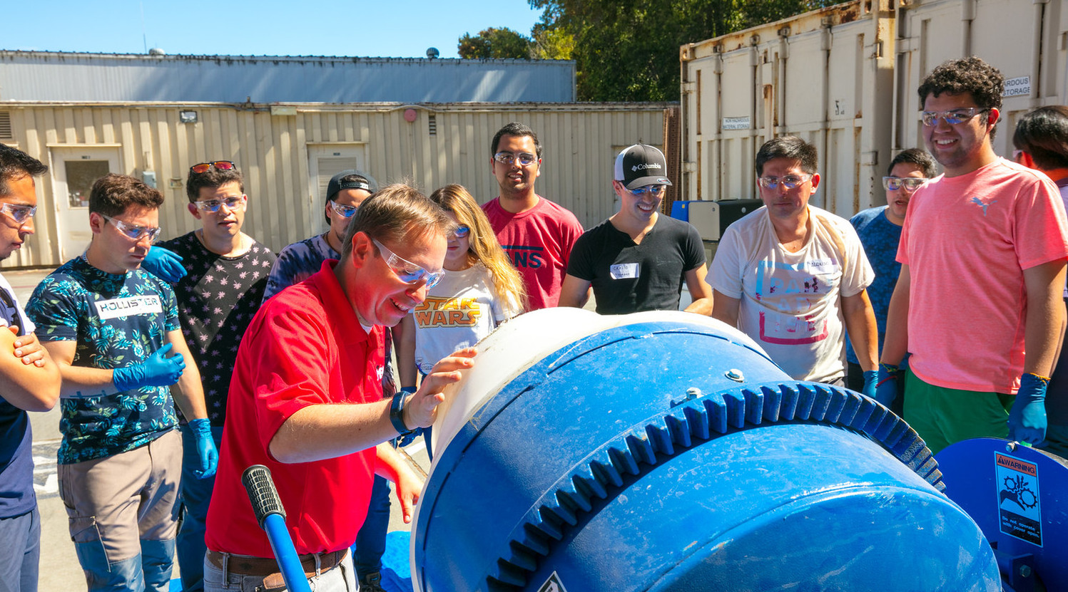 a group of Chilean students gathered around a construction management tool