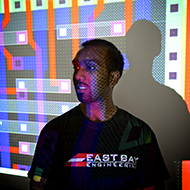 A student stands in front of a projected engineering graph