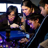 A group of students work on a physics instrument
