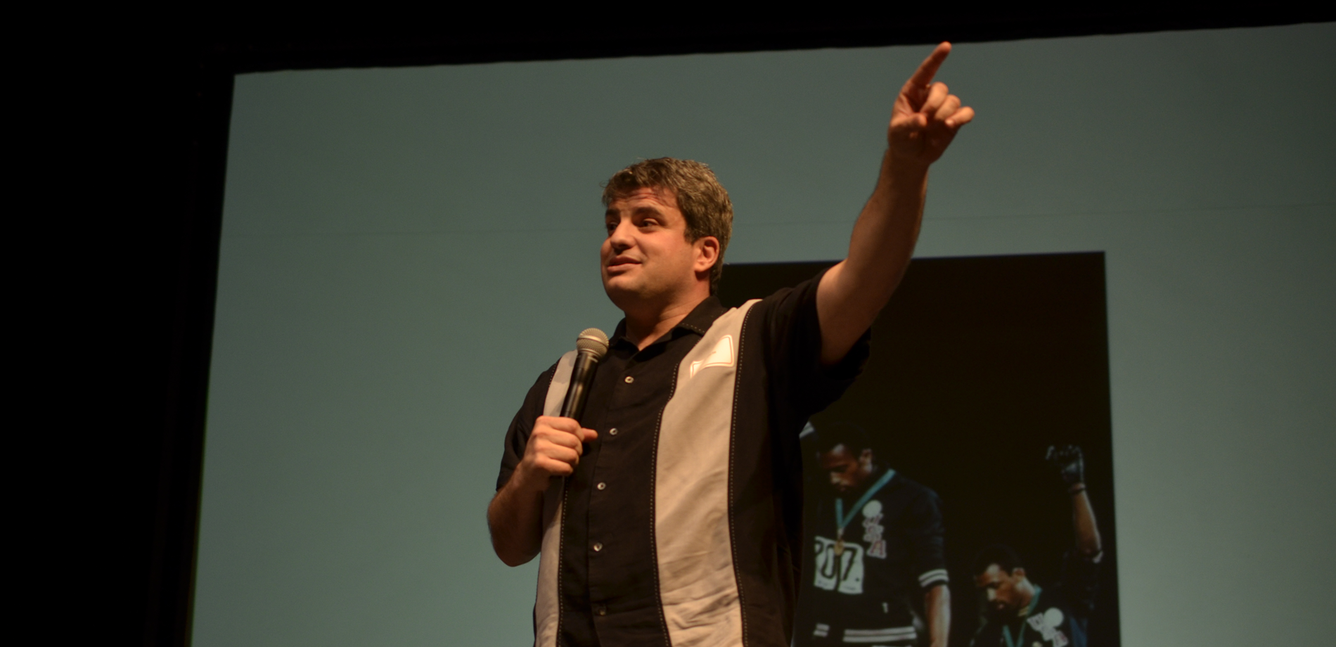 man speaking holding a mic