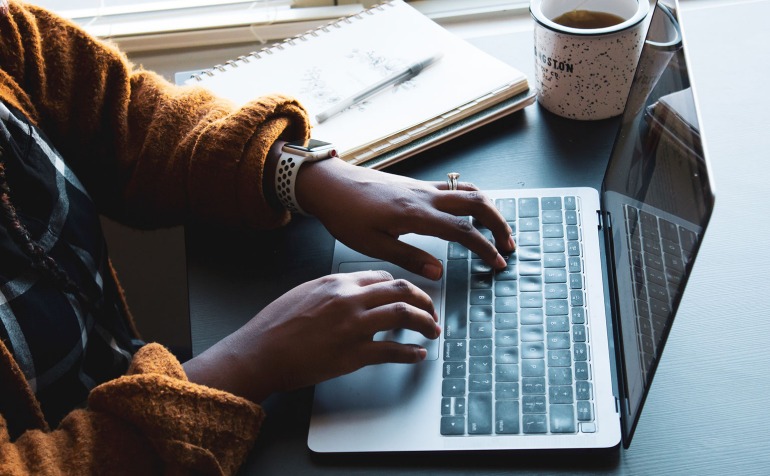 Black woman typing on the computer