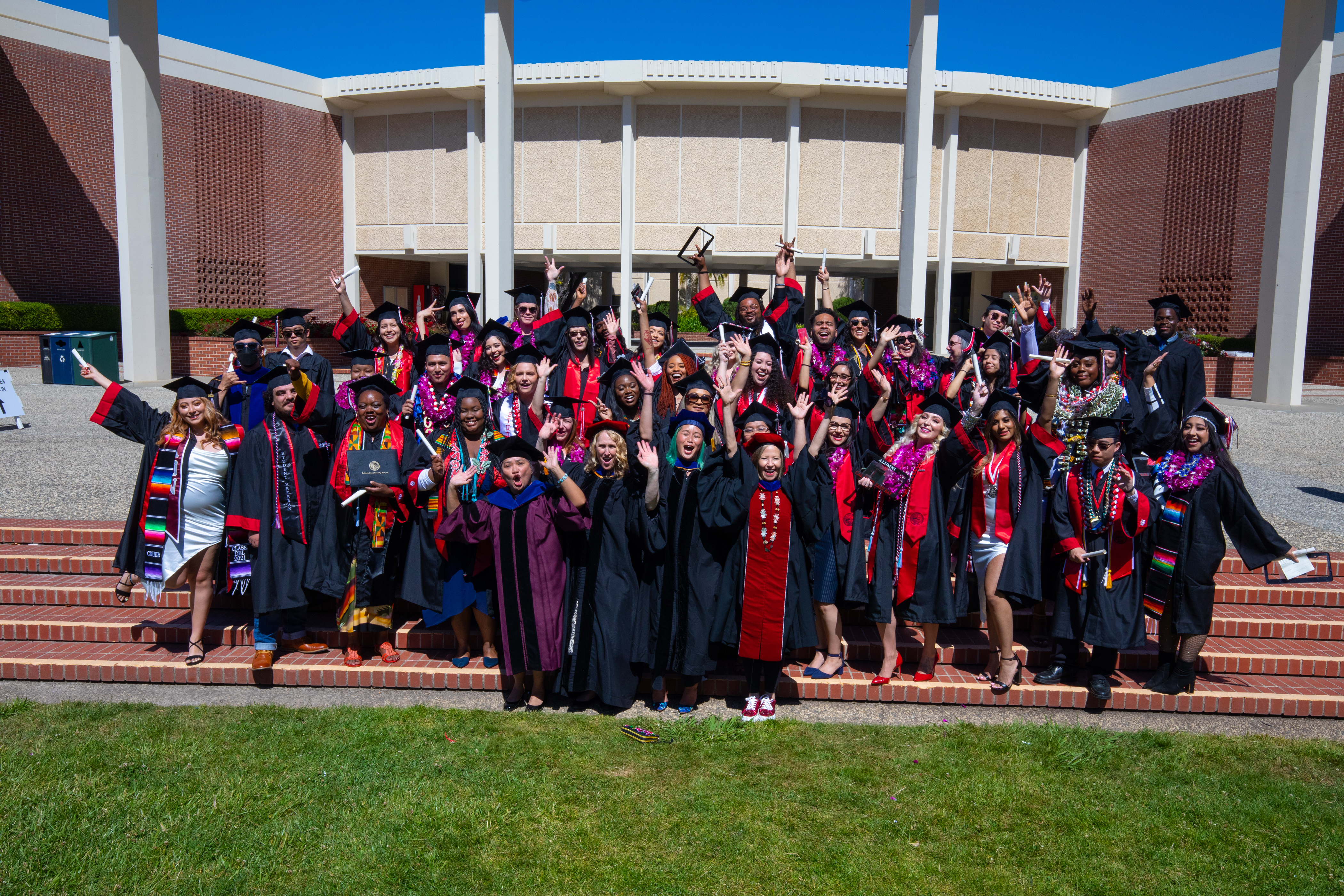 Graduates celebrate in front of the Music Building