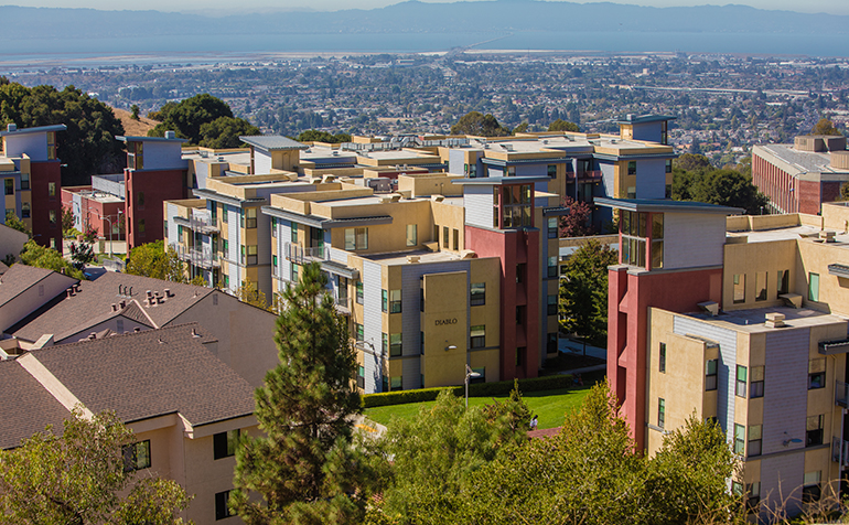 Pioneer Heights on-campus housing with bay in the background