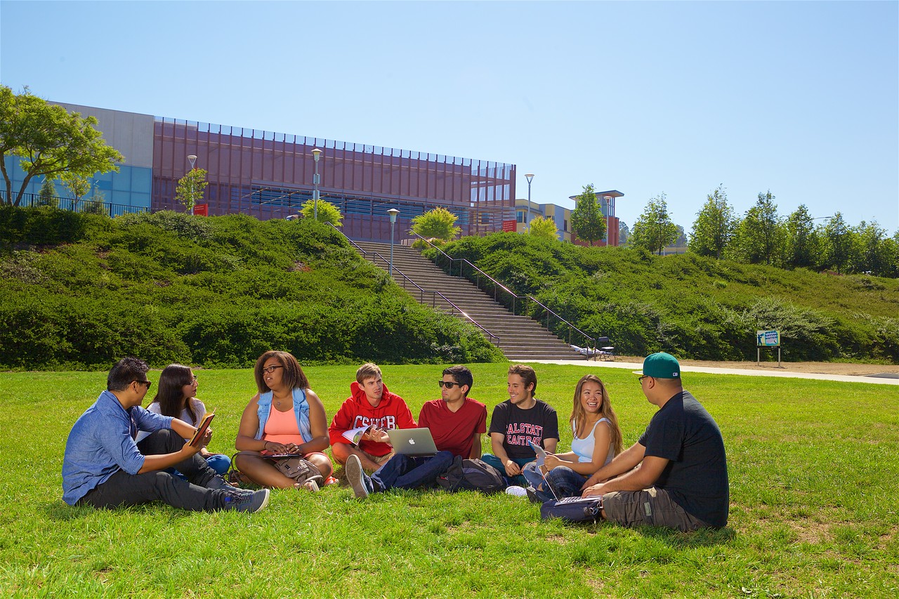 students on lawn in front of the recreation and wellness center
